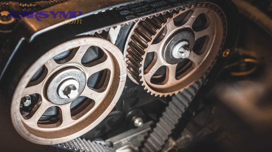 Worn timing belt showing cracks and wear before replacement