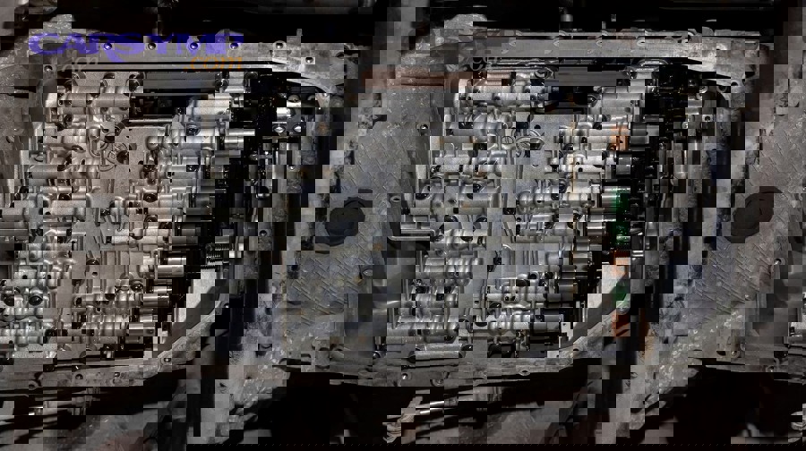 Mechanic performing transmission-related automotive service