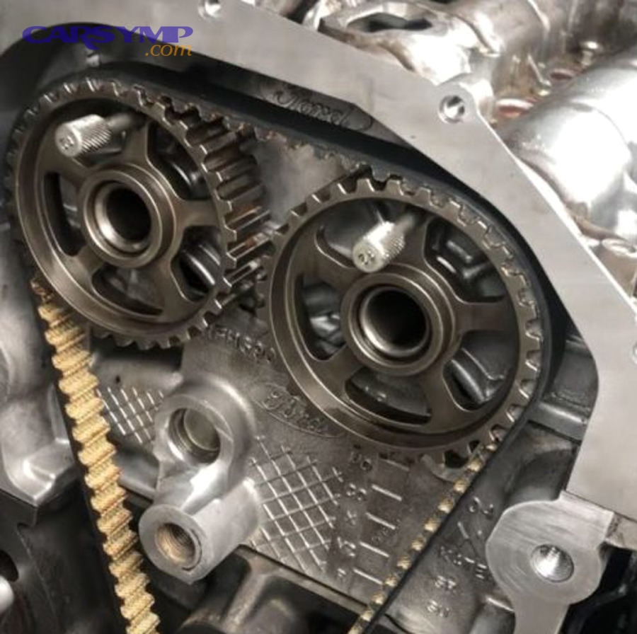 Timing belt system showing belt, tensioner, and pulleys in an engine bay